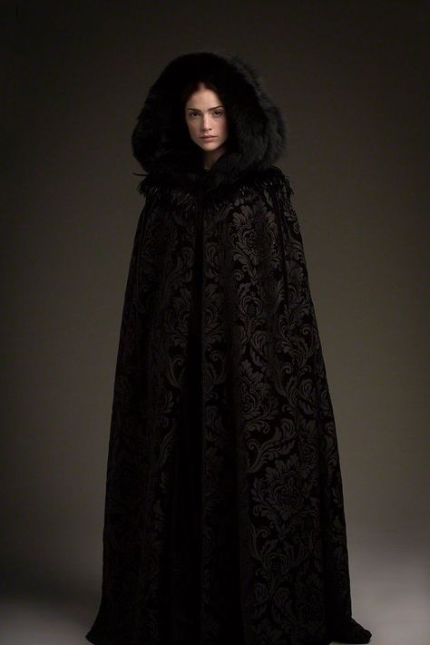 Full length Mary Sibley in the black velvet brocade cape.  A look that Salemites love! Luxury Medieval Cape For Cosplay, Luxury Medieval Cape Outerwear, Luxury Black Gothic Cape, Luxury Medieval Winter Cape, Medieval Winter Cape, Mary Sibley, Janet Montgomery, Black Cloak, Promotional Photos