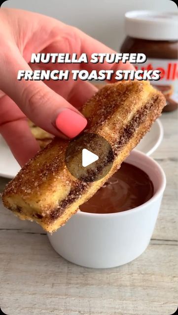 Foodie | Recipe | Delicious on Instagram: "NUTELLA 🍫STUFFED FRENCH TOAST 🍞 RECIPE  Ingredients:  French Toast:  	•	6 slices of bread (preferably brioche or challah) 	•	2 large eggs 	•	60 ml (1/4 cup) milk (any type) 	•	1 tsp vanilla extract 	•	3-5 tbsp Nutella  Cinnamon Sugar Coating:  	•	3 tbsp granulated sugar 	•	1 tsp cinnamon  Instructions:  	1.	Prepare Sandwiches: 	•	Spread Nutella between two slices of bread to form sandwiches. 	2.	Mix Eggs: 	•	In a shallow dish, whisk together eggs, milk, and vanilla. 	3.	Make Cinnamon Sugar: 	•	Combine sugar and cinnamon in a separate bowl. 	4.	Cook: 	•	Dip each sandwich in the egg mixture, then fry in a preheated skillet over medium heat until golden, about 2-3 minutes per side. 	5.	Coat: 	•	Toss the hot French toast in cinnamon sugar until coat Nutella Stuffed French Toast Sticks, Stuffed French Toast Sticks, Nutella Stuffed French Toast, Nutella Shake, Nutella Donuts, Nutella Waffles, Nutella Sandwich, Nutella Pizza, How To Make Nutella