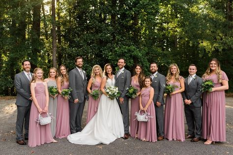 Wedding party in mauve and grey outfits. Bridesmaids in mismatched mauve dresses. Groomsmen in light charcoal grey suits. Mauve and grey wedding colors. See more of this classic Mississippi wedding! Dusty Rose Charcoal Gray Wedding, Grey Groomsmen Suits With Dusty Rose, Dusty Rose And Charcoal Grey Wedding, Charcoal Gray Wedding Suit, Charcoal Tuxedo Wedding Groomsmen, Wedding Colors Bridesmaids And Groomsmen, Charcoal Grey Wedding Theme, Dusty Rose Wedding Party Groomsmen, Groomsmen Attire Dusty Rose