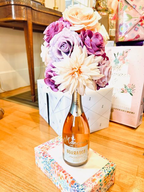 Wine Bottle Centerpieces For 50th Birthday Party, Flower Arrangement On Top Of Wine Bottle, Wine With Flowers On Top, Champagne Bottle Flower Arrangements, Wine Bottle With Flowers On Top, Wine And Flowers Gift Boxes, Homemade Champagne, Champagne Centerpiece, Flowers And Wine