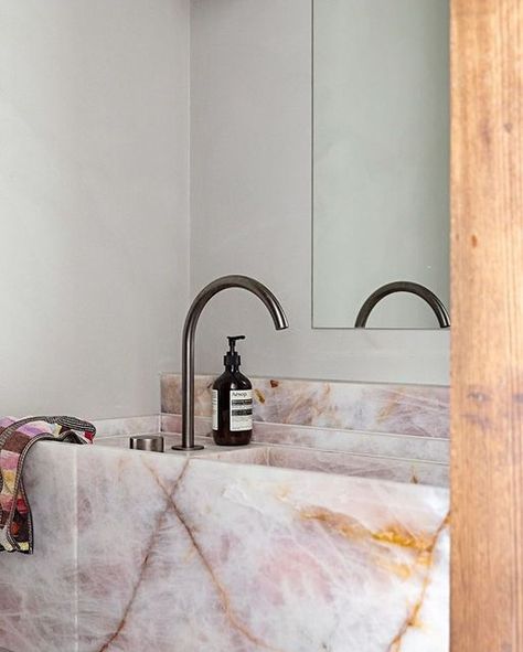 CDK Stone on Instagram: "Rosa Calmante has been used throughout the home of AFLW star Katie Brennan and partner Olivia Christie's with a feature vanity in the bathroom.⁣ Designed by @bergmanandco ⁣⁣ Image by @nataliejeffcott ⁣⁣ ⁣⁣ #cdkstone #rosacalmante #naturalstone #naturalbeauty #naturesmasterpiece #designstyle #natural #stone #interiors #exteriors #designinspo #designinspiration #natural #interiors #stone #interiordecor #designoftheday" Pink Marble Sink, Rose Quartz Bathroom, Pink Marble Bathroom, Natural Interiors, Bathroom Bench, Stone Bathroom Sink, Quartz Bathroom, Quartz Sink, Stone Vanity