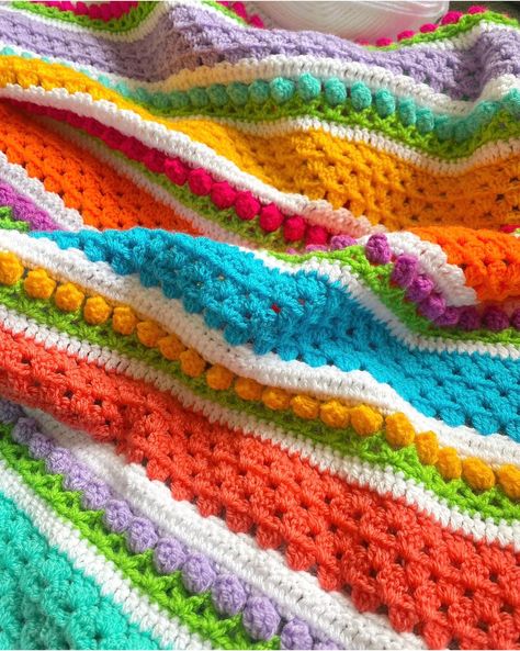 This beautifully bright and bold crochet blanket is guaranteed to bring a pop of colour into any room in your home. Its unique design with the puffed out crochet stitches give the illusion of rows of flowers in a field if you like all things flowers and rainbows then look no further. This blanket would make a lovely gift to give to a friend or loved one or simply as a treat for yourself.    🫧Washing instructions... Blanket is machine washable on a cool 30 degree wool cycle or handwash if this is your preffered method. Do not tumble dry, lay out flat to dry if possible this helps your blanket keep its shape. clothes airers are also a good method to use for drying.  Follow us on instagram  (@skittlebowcrochet) Visit our website  (https://www.skittlebowcrochet.com/) Blue Crochet Blanket Color Schemes, Blanket Color Schemes, Crochet Blanket Color Schemes, Stripe Crochet Blanket, Flowers And Rainbows, Rows Of Flowers, Blue Crochet Blanket, Flowers In A Field, Crochet Blanket Colors