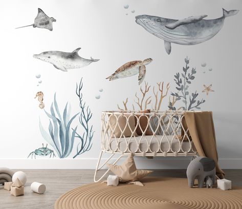 Transform any room into an enchanting under the sea paradise with our Ocean Theme Wall Decal Pack. Dive into the deep blue with these captivating decals, including a dolphin, blue whale, turtle, manta ray, crab, seaweed, and coral. Create a serene under the sea setting with these easy-to-apply and remove decals. Perfect for nurseries, bedrooms, playrooms, or classrooms, these decals will bring the ocean's magic to your space. Make your room a vibrant aquatic wonderland today! Ocean Themed Nursery Wallpaper, Under The Sea Baby Room, Ocean Baby Room, Dolphin Nursery, Sea Themed Nursery, Baby Manatee, Sea Life Nursery, Under The Sea Nursery, Paint Walls