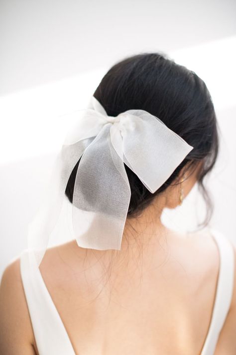 Low Bun Wedding Hair With Bow, Wedding Updo With Bow, Unique Wedding Veils Short, Bun With Bow Hairstyle, Wedding Hair With Bow, Hair Bow Bun, Bridal Hair Bow, Wedding Hair Bow, Bun Bow