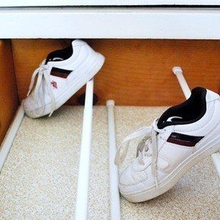 Transform a drawer into a shoe cabinet with the help of four tension rods. | 7 Easy Organizing Tricks You'll Actually Want To Try Shoe Cabinet Inside, Shoe Drawer Organization, Shoes Drawer Ideas, Diy Underbed Shoe Storage, Shoes In Dresser Drawer, Tension Rod Shoe Rack, Diy Shoe Drawer, Toddler Shoe Organization, Drawer Shoe Storage