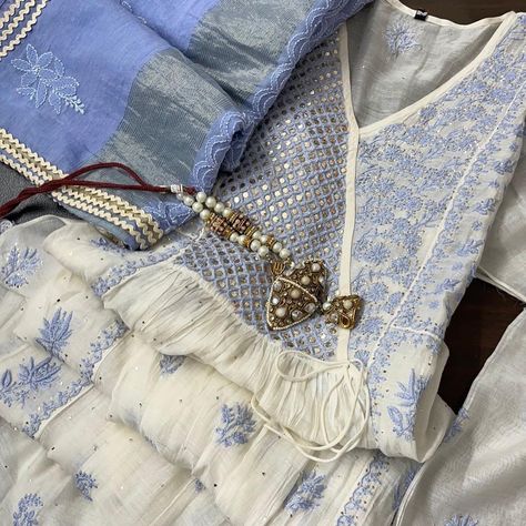 * Class apart* *classy offwhites w Prewinkle blue embroidery in angrakha pattern * Very Soft mulmul tunic and dupatta , heavy chikankari embroidered angrakha yoke w contrast , Mukesh on side panels of yoke, jaali bootas on centre panel and small booties all over Teamed with Chanderi dupatta, heavy embroidery pallus work , finished w laces #partywearsuits #chanderisilk #kaamdani #mukaishchikan #chikankari #chikankarikurtis #chikankarisaree #lucknowi #revaboutique86 #embroidery Embroidered Neck Designs, Chudi Neck Designs, Ethenic Wear, Partywear Suits, Chanderi Dupatta, Organza Suits, Cotton Gowns, Pakistani Fancy Dresses, Long Dress Design