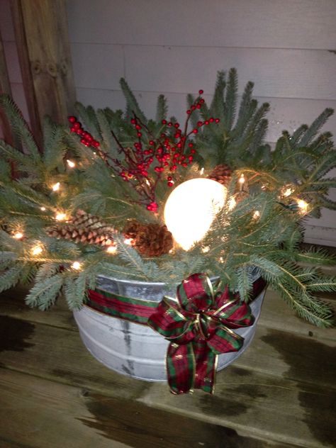 Christmas galvanized bucket. Fresh pine branches, pine cones, berries sprigs a plastic globe light cover stuffed with white lights and a ribbon. Galvanized Bucket Christmas Decor, Galvanized Christmas Decor, Galvanized Bucket Decor Christmas, Minnow Bucket Decor, Coal Bucket Ideas Decor, Galvanized Tub Christmas Decor, Coal Bucket Christmas Decor, Galvanized Christmas Buckets, Bucket Decorating Ideas