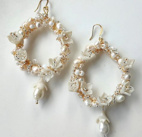 For the maximalist bride who still wants to be romantic 💘 Delicate florals, pearls and beads hand crafted with single pear drop pearls for plenty of movement and face framing. Wear with lacy high necks, crisp ball gowns or slinky silk chemise dresses. #bridalearringideas #handcraftedbridal #wearablebridalaccessories #uniqueweddingearrings #weddingjewellery #bridaljewellery #gibsonbespoke #gibsonbespokeluxurybridal #madeinengland #handcraftedinengland #luxuryweddings #couturebride Maximalist Bride, Unique Wedding Earrings, Chemise Dress, Silk Chemise, Winter Flowers, Luxury Bridal, Pearl Hoop Earrings, Face Framing, Bridal Necklace