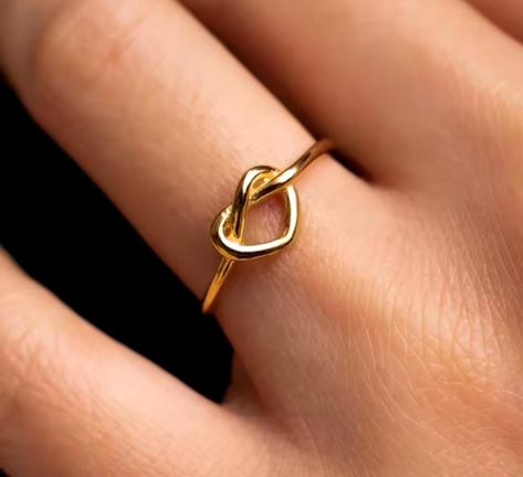 Express your love and elegance with our Infinity Heart Knot Ring, a timeless and meaningful piece symbolizing eternal love and deep connections. This delicate open-band ring features a beautifully intertwined heart and infinity symbol, making it a perfect gift for anniversaries, birthdays, or simply to show appreciation to someone special. Crafted from high-quality gold-plated or silver-plated metal, this ring is designed for both comfort and style. Its adjustable band ensures a perfect fit for various finger sizes, making it a versatile piece for everyday wear. Whether worn alone for a minimalist look or stacked with other rings, its elegant and modern design makes it an eye-catching accessory. Perfect for: ✨ Romantic Gifts - Anniversary, Valentine's Day, Birthday, or Wedding Gift ✨ Best Heart Knot Ring, Heart And Infinity, Heart Knot, Best Friend Jewelry, Zierlicher Ring, Romantic Jewelry, Romantic Jewellery, Infinity Heart, Knot Ring