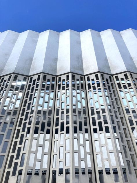 The NSM Service Building is a new part of the Malmö hospital area. The facade elements in front of the gas and fuel filling station are designed for better ventilation to reduce the risk of explosion. These shapely and perforated elements are manufactured in GRC, as the material allows for the perforated pattern, while also being strong and stable enough to hold. #bbfiberbeton #fiberbeton #GRC #GFRC #GRCA #facade #concretefacade #architecture #pattern #concretearchitecture #facadedesign #design Grc Facade, Facade Elements, Architecture Pattern, Facade Pattern, Concrete Facade, Concrete Architecture, Food Medicine, New Building, Filling Station