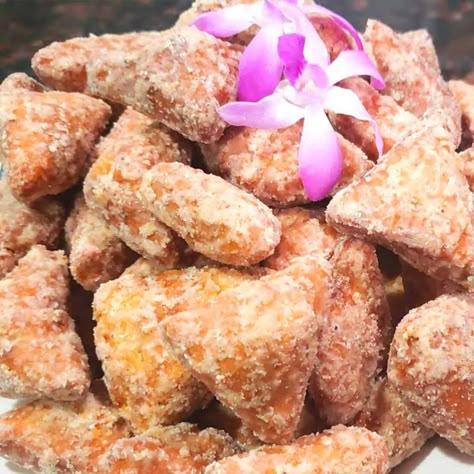 This mithai is a soft, fried fitter is a popular treat at Guyanese and Trinidadian special occasions such as weddings. These soft mithai is made with flour, butter, fresh coconut, anise seed, and evaporated milk. It's fried till golden brown then tossed in a sugar syrup until crystallized. She only made these on Hindu holidays such as Diwali and Holi, and other religious functions. These sweets were just one among many that we enjoyed during auspicious times of year. We also made peera, a crunch Guyanese Recipes Desserts, Guyanese Mithai Recipe, Guyanese Desserts, Super Easy Snacks, Hindu Holidays, Guyana Recipes, Mithai Recipe, Guyana Food, Carnation Milk