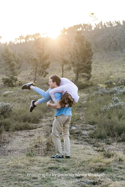 Man carrying woman on his shoulder, could be a funny idea for Save the Date photo shoot. Carry Her In His Arms, Carried Over Shoulder Couple, Boyfriend Carrying Girlfriend Over Shoulder, Carrying Girlfriend Over Shoulder, Shoulder Carry Pose Reference, Bride Carry Pose Reference, Over The Shoulder Carry Pose, Types Of Carrying People, Man Carrying Woman Over Shoulder