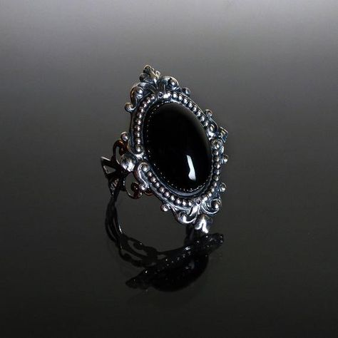 This ornate ring features a natural gemstone Black Onyx cabochon set in a beautifully decorative mount (measuring 35 x 25 mm) on a stunning filigree band. The Sterling silver plated filigree ring is adjustable so one size fits all. Nickel and lead free. This Sinistra Black Onyx filigree ring compliments perfectly our Sinistra lace choker which can be found in our Etsy store. The full Sinistra range of venise lace chokers and matching rings are available in Black Onyx, Black cameo, Sapphire blue, Medieval Wedding Ring, Gothic Jewelry Rings, Gothic Wedding Rings, Goth Ring, Gothic Engagement Ring, Ornate Ring, Steampunk Rings, Gothic Ring, Black Gold Ring