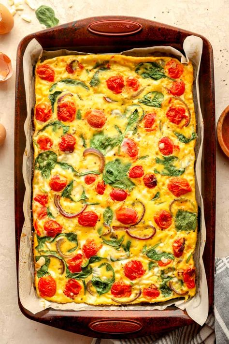 These Sheet Pan Eggs are a breakfast prep dream-come-true! They come together with your favorite veggies, cheeses, and meats to create a hearty egg frittata. Enjoy as-is with your favorite breakfast side dishes or meal prep and make into freezer breakfast sandwiches! Sheet Pan Frittata, Sheet Pan Breakfast Sandwiches, Sheet Pan Eggs In The Oven, Sheet Pan Eggs, Egg Frittata, Freezer Breakfast Sandwiches, Spinach Bake, Breakfast Sides Dishes, Breakfast Meat