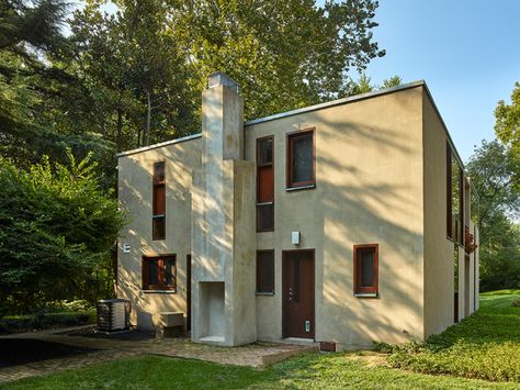 A cleaner, more organized east elevation was achieved by moving utility lines and meters and restoring the stucco to original condition.