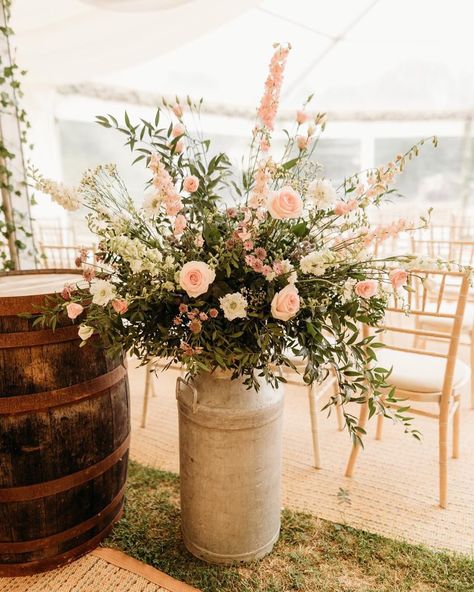 If your wedding has a rustic country style feel to it having milk churn arrangements are a great way to add to that style. Easily moved they can be repurposed to get the most out of them throughout your day and into the evening. Milk Churn Centerpiece Wedding, Milk Jug Wedding Decor, Milk Churn Wedding Flowers, Wedding Whiskey Barrel Floral Arrangements, Wedding Flowers On Whiskey Barrels, Rustic Flower Arrangements Wedding Whiskey Barrels, Milk Churn, Country Wedding Flowers, Pastel Wedding Flowers