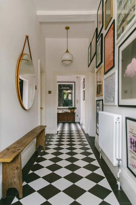 A hallway spiced up by the choice of black and white tiled flooring and numerous frames Bert And May Tiles, Pastel Interiors, Small Staircase, Colorful Terrazzo, Georgian Mansion, Tiled Hallway, Pastel Interior, Georgian House, Black And White Tiles