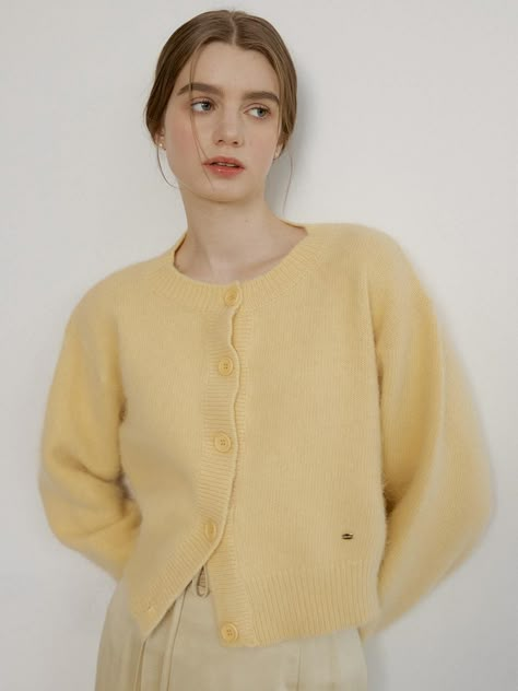 Ivory angora-wool blend cardigan sweater with REORG signature logo in 18k gold. Round neckline, long sleeve, and buttons at front.    - Round neckline- Button closure- Long sleeve Crew Neck Cardigan Knitting Pattern, Butter Yellow Sweater, Collared Cardigan Outfit, Fluffy Cardigan Outfit, Pink Cardigan Outfit Aesthetic, German Style Fashion, Wool Cardigan Outfit, Ivory Clothes, Button Up Sweater Outfit