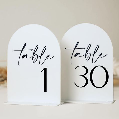 PRICES MAY VARY. Modern Arch Acrylic Table Numbers: Number your wedding tables with a modern arch acrylic sign to display as the centerpiece! These stylish arched black acrylic table numbers will match any themed event and can be used over and over again. Minimalistic Design: The white arch acrylic table numbers is the most popular wedding decoration at the moment, and the minimalist style will never go out of fashion. The calligraphy numbering on acrylic sign is breathtaking. What a beautiful p White Arch Wedding, Arch Table Numbers, Modern White Table, Table Numbers For Wedding, Wedding Reception Centerpiece, Arch Table, White Arch, Acrylic Table Numbers, Acrylic Table Number