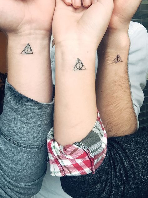 One of the first things my brothers & I bonded over was Harry Potter. For Christmas, we decided to get matching Deathly Hallows tattoos - each with one solid part and two unfinished parts, symbolizing us each being one part of the whole. Alex, the oldest, got the elder wand. I, the middle child, got the resurrection stone and Austin, the youngest, got the cloak of invisibility. Small Sibling Tattoos, Matching Harry Potter Tattoos, Always Harry Potter Tattoo, Ravenclaw Tattoo, Tiny Harry Potter Tattoos, Slytherin Tattoo, Resurrection Stone, The Elder Wand, Matching Tattoo Ideas