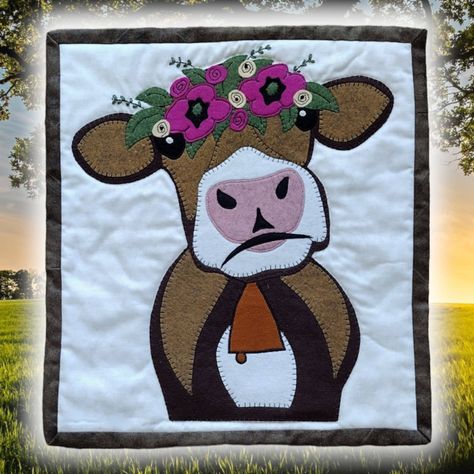 "Brown Cow Wall Quilt Kit from Rachel's of Greenfield - SKU: K0323 The Brown Cow Wall Quilt Kit includes everything needed to complete a 13\" x 15\" wall hanging top. The batting and backing are not included in this kit. The binding fabric is included.  The Brown Cow Kit is a close encounter with a friendly cow. The flowers on the head of the cow and the copper bell around her neck add to her charm.   The Brown Cow Quilt Kit is not complicated. Pieces are cut using templates that are included wi Cow Quilt, Cow Applique, Forest Critters, Cow Craft, Wall Hanging Quilt, Wall Quilt Patterns, Decorative Stitches, Illustrated Instructions, Hanging Quilts