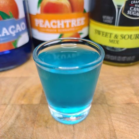 The Best Blue Balls Shot Recipe | Occasional Cocktails Blue Balls Cocktail, Blue Balls Drink, Blue Curacao Shots, Disney Inspired Cocktails, Adult Beverages Recipes, Blue Shots, Liquor Shots, Shots Shots Shots, Jell O Shots