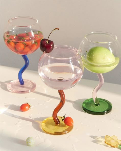 Bring a bubbly style to your wine glass with this contemporary twist-handled piece. Crafted from borosilicate glass in bright colors, it’s sure to be the talk of the table. • Borosilicate Glass • 300ml • Base 2.5" x Caliber 3.5" x Height 6.2" (6.5 x 8.77 x 16cm ) Burgundy Wine Glasses, Colored Wine Glasses, Pinterest Predicts, Colored Bubbles, Dopamine Decor, 2025 Trends, Wine Collection, Wine Cups, Candle Accessories