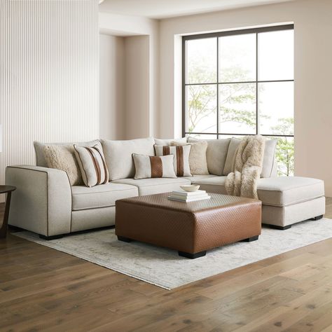 The clean lines of the light beige boucle fabric and warm brown accent colors of the leatherette showcased on the Hersh Sectional create a welcoming ambiance for any living space. Beige Ottoman Living Room, Beige Leather Couch Living Room, Beige Sectional Living Room, Living Room With Ottoman, Sectional And Ottoman, Cream Leather Sofa, L Shaped Sectional, Beige Couch, Beige Sectional