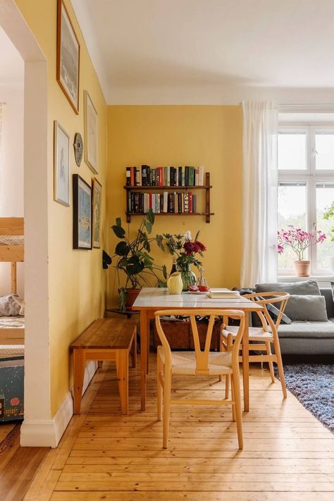 Yellow Wall Apartment, Yellow Front Room, Yellow Floor Living Room, Yellow Playroom Walls, Living Room Wall Color Yellow, Dining Room Decor Colorful, Butter Yellow Living Room, Living Room With Breakfast Nook, Apartment Ideas Colorful