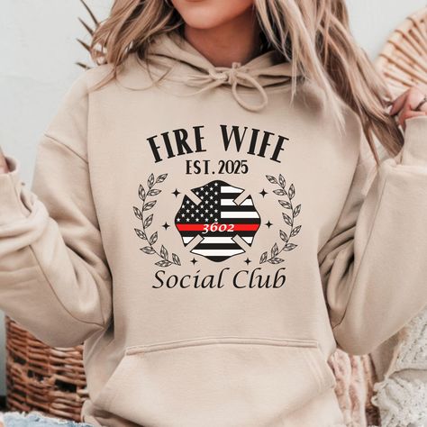 Fire Wife Social Club Sweatshirt, Hoodie, Long Sleeve Tee or T-shirt is the perfect gift for any fire fighter wife for birthday, Christmas, or Anniversary! In the personalization box, enter the year you became a fire wife and your firefighter's name or number, if desired (Ex: 2025, 3602) T-shirt: This is made with the Bella & Canvas 3001 classic unisex jersey short sleeve tee.  It fits like a well-loved favorite, soft cotton and quality print make users fall in love with it over and over again. These t-shirts have-ribbed knit collars to bolster shaping. The shoulders have taping for better fit over time. Dual side seams hold the garment's shape for longer.  .: 100% Airlume combed and ringspun cotton (fiber content may vary for different colors) .: Light fabric  .: Retail fit .: Tear away l Fiance Sweatshirt, Cop Wife, Deputy Wife, Police Officer Wife, Wife Sweatshirt, Wife Tshirts, Leo Wife, Deputy Sheriff, Wife To Be