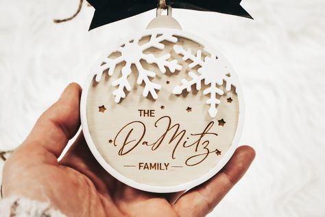 "A personalized ornament is the perfect keepsake for your first home this Christmas. They also make great stocking stuffers and gift tags for Christmas! --ABOUT THE ITEM-- -Size: 3.6\" Round -Wood & Acrylic material. Comes with black ribbon and twine -Engraved design We do not offer returns/exchanges on personalized items. **NO CANCELLATIONS ON CUSTOMIZED ITEMS** SHIPPING UPDATE We are not responsible for any delays in shipping due to US Postal Service and orders will not be refunded. Please use. #ChristmasLaserCut #FreeHolidayDecor #DIYChristmasCrafts #ChristmasCrafting Christmas Laser Cut Ideas, Laser Ornaments, Glowforge Christmas, Laser Engraved Christmas, Gift Tags For Christmas, Lézervágott Fa, Christmas Ornaments Wood, Acrylic Christmas Ornaments, Laser Christmas