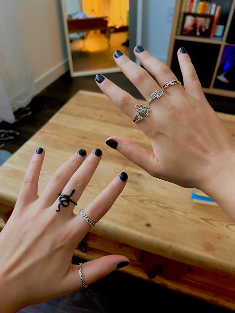 Lesbian hands with black nail polish. 5 silver rings and one black ring. Ring on left middle finger is a black snake. Ring on left middle finger is some sort of ancient writing. Ring on left thumb is a chain. Ring on right index finger is an elephant. Ring on right middle finger is leaves. Ring on right middle ring finger is a horse Rings Lesbian Style, Lesbian Jewelry Style, Masc Hands With Rings, Masc Lesbian Rings Aesthetic, Masc Lesbian Jewelry, Masc Women Jewelry, Lesbian Rings Hands, Lesbian Rings Aesthetic, Masc Rings For Women