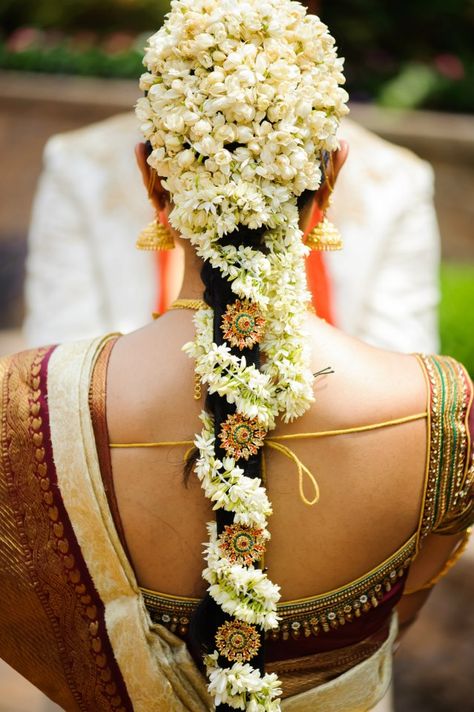 .The South Indian Bride with Mogra Flowers Beautifully done in her hair. #MystiqueWeddingStories Hairstyle With Jasmine, Bridal Hairstyle Indian Wedding, Ben Johnson, Bridal Hairdo, Saree Bollywood, Jasmine Flowers, Indian Wedding Hairstyles, Hairdo Wedding, Wrap Hair