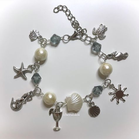 vacation charm bracelet 🌅🐚🪼🐬 alsooo more matching sets coming soon 🫶🏻 i stocked a few of the ones on the second slide and they sold out super fast so i’ll bring them back !! 🫶🏻 #charmbracelet #bracelet #holidayoutfit #vacationoutfit #summer #pinterest #fashion #coquette #dollette #y2k #indie #mermaid #mermaidcore #handmade Mermaid Drink, Fashion Coquette, Mermaid Inspired, Pinterest Fashion, Vintage Aesthetic, Holiday Outfits, Starfish, Matching Sets, Beach Vacation