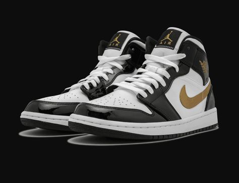 The Air Jordan 1 Mid “Black/Gold Patent Leather” is a premium edition of the classic model featuring a striking patent leather upper in black, white, and metallic gold. The mid-top Jordan 1 receives this refined look in the always-stylish color combination that is reminiscent of the Air Jordan 1 High “Gold Top 3,” but with the color blocking remixed for a fresh new appearance and feel. The Air Jordan 1 Mid “Black/Gold Patent Leather” released in early 2019. Black And Gold Color Scheme, Jordan 1 Mid Black, Air Jordan 1 Mid Black, Air Jordan 1 Mid Se, Pretty Shoes Sneakers, Gold Color Scheme, Jumpman Logo, Nike Air Shoes, Wings Logo