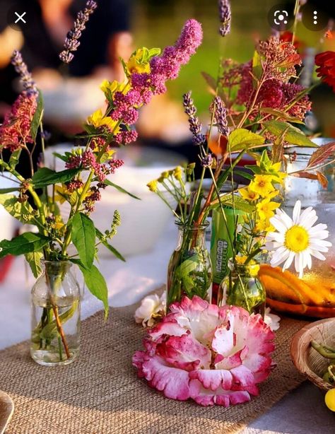 3 glass jars or bottles with bright meadow or wild flower style flowers, on a hessian table runner Farmhouse Table Setting Ideas, Tropical Wedding Reception, Hessian Table Runner, Table Runner For Wedding, Burlap Runner, Bright Wedding Flowers, Pub Wedding, Burlap Runners, Burlap Table