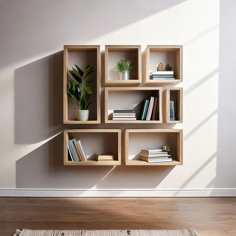 Introducing our stylish and functional set of 7 wall-mounted bookshelves, designed to enhance your living space while providing practical storage solutions. Crafted from durable melamine wood, these shelves are built to last, offering both aesthetic appeal and long-term reliability. With a total width of 100 cm and a height of 100 cm, the set is compact yet spacious, making it a perfect addition to various rooms in your home, including the living room, kitchen, home office, or bedroom. Key Featu Bookshelf Design Wall Small Spaces, Living Room Shelves Ideas, Room Shelves Ideas, Minimal Bookshelf, Staggered Shelving, Book Shelves Wall, Living Room Wall Shelves, Couch Shelf, Floating Shelf Modern