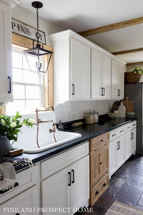 Farmhouse kitchen with a wood dishwasher panel #kitchendecor #farmhousekitchen #farmhousedecor #farmhouse #fixerupper #whitekitchen #kitchen #rusticdecor Pine And Prospect Home, Pine And Prospect, Farm Sinks, Lanterns Chinese, One Wall Kitchen, Cottage Style Kitchen, White Subway Tile Backsplash, Black Countertops, Cottage Style Home