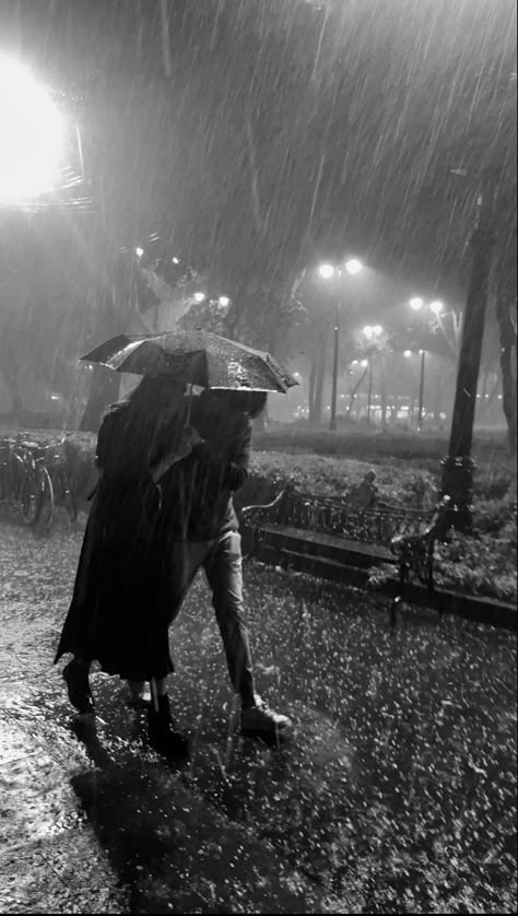 A man and a woman walking under an umbrella while it rains Umbrella Couple Aesthetic, Couple Under Umbrella Aesthetic, Couple In Rain, City Rain, Under An Umbrella, Rain Photo, Rain Wallpapers, Night Rain, Under The Rain