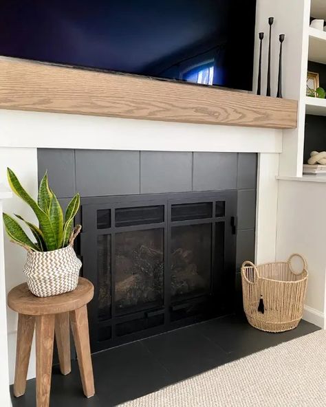 As part of this fireplace makeover, learn how to make a mantel and paint tiles to update the look of your fireplace. No Tile Fireplace, Diy Fireplace Makeover Rental, Fireplace Surrounds And Mantels Tile, Townhouse Fireplace Makeover, Tile Around Fireplace Ideas Mid Century, Diy Rental Friendly Fireplace, Diy Fireplace Refacing, Shiplap Over Tile Fireplace, Tile Pellet Stove Surround