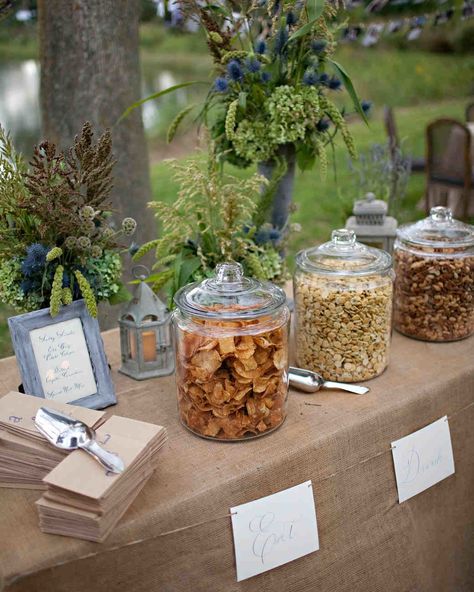 Salty Snacks Before guests arrived at the ceremony, pre-ceremony snacks like Old Bay-seasoned potato chips, spiced nuts, and dilled oyster crackers were set out on a table with paper bags and scoops so guests could help themselves. Chips At Wedding, Late Night Snack Table Wedding, Sweet And Salty Table Wedding, Outdoor Snack Bar, Chip Bar Wedding, Easy Wedding Snacks, Chip Buffet, Ceremony Snacks, Wedding Table Snacks