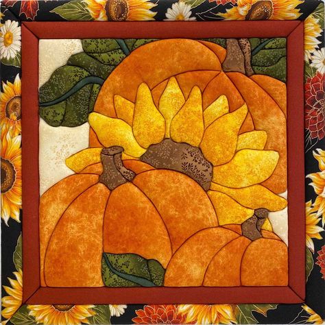 This no-sew quilted art features a harvest collage of three pumpkins and a sunflower framed by autumnal fabrics. No sewing skills are needed to create this decorative quilted wall art. Simply follow the instructions to punch the fabric pieces in placejust like magic! Quilt Magic kit includes laser cut foam board, fabrics (may vary), and instructions to create the no-sew quilt design. Punch tool and frame are not included. Made in U.S.A. Quilt magic kit includes laser-cut foam board, fabrics, and Quilted Wall Art, Fall Quilt Patterns, Patchwork Quilting Designs, Applique Wall Hanging, Big Block Quilts, Sunflower Quilts, Fall Arts And Crafts, Wool Applique Patterns, Christmas Applique