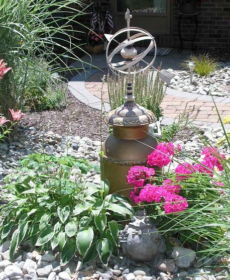 How to disguise an ugly pipe. Well Cover Ideas, Metal Desk Makeover, Well Pump Cover, Mary's Garden, Well Covers, Hand Water Pump, Pump Covers, Old Milk Cans, Garden Bench Diy