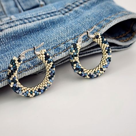 Denim Beaded Hoop Earrings Mesmerizing Light-Reflecting Effect      Looking for earrings that match perfectly with your favorite jeans or jean jacket? These denim beaded hoop earrings are created especially for denim lovers. Made with unique silk satin beads, they shine beautifully and reflect light from different angles, creating a captivating effect. Crafted using six types of beads to mimic denim fabric but with varied textures, these earrings look even better in person, with a fantastic shin Abstract Beaded Earrings, Seed Bead Jewelry Tutorials, Shiny Earrings, Pad Bag, Multicolor Earrings, Art Earrings, Beaded Hoop Earrings, Beaded Hoops, Seed Bead Earrings