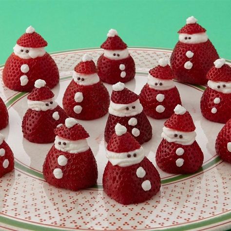 Mini Strawberry Santas | "You can easily make these little Santas as a holiday dessert yourself. All you need are strawberries, whipped cream, and some chocolate sprinkles. Your kids will love these yummy treats and can help put them together." Santa Recipes, Strawberry Santas, Snacks Sweet, Christmas Dessert Table, Decorações Com Comidas, Christmas Fruit, Christmas Brunch, Xmas Food, Holiday Appetizers