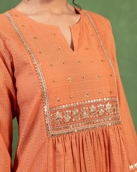 Festive’24 - New Arrivals! A pretty peach dobby kurta, perfect for festive occasions. Gold trims and lace at the yoke and on sleeve cuffs enhance the soft peach hue, This kurta combines traditional elements with flair while maintaining a flattering shape. [ Cottons, Cottons Jaipur, New Arrivals, Festive Collection, Durga Puja, Navratri, Garba, Ethnic wear ] #cottons #cottonsjaipur #festive #newcollection #newarrivals #festiveseason #navratri #garba #colours #ethnicwear #festivefashion #c... Kurta Yoke Design, Women Kurta Designs, Yoke Designs, Cottons Jaipur, Diwali 2024, Navratri Garba, Yoke Design, Designer Kurti Patterns, Kurti Patterns