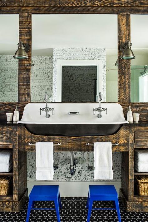 Country style bathroom designed for boys featuring a Kohler Brockway trough Sink with two faucets surrounded by reclaimed wood millwork fitted with satin nickel towel bars over cobalt blue step stools. Bathroom Trough Sink, Kohler Brockway Sink, Rustic Cottage Bathroom, Farmhouse Trough Sink, Kohler Brockway, Cabin Master Bath, Country Style Bathroom, Master Bath Sink, Navy Blue Shower Curtain