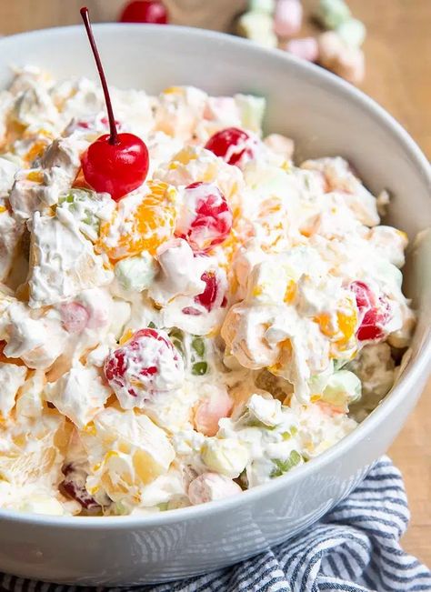 This Ambrosia Salad is a creamy fruit salad that is so easy to make, and so delicious, it's practically dessert. It's a perfect side dish for a summer bbq, holiday dinner, or any day of the year. Macroni Salad, Samoa Pie, Mango Desert, Ambrosia Salad Recipe, Cherry Fluff, Pineapple Fluff, Ambrosia Recipe, Ambrosia Fruit Salad, Creamy Fruit Salads