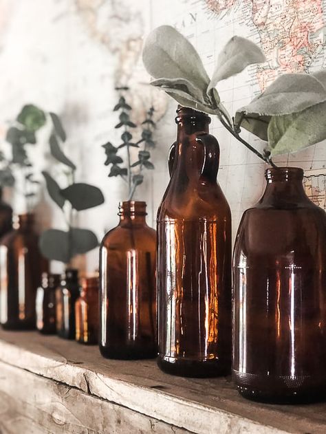 Looking for easy ways to add fall home decor to your home? These simple tips will help you do just that. Brown Bottles With Flowers, Fall Decorating With Amber Bottles, Amber Glass Bottles Decor, Amber Bottle Fall Decor, Decorating With Amber Bottles, Brown Glass Bottles Decor, Amber Bottles Decor, Brown Bottle Decor, Vintage Bottles Decor