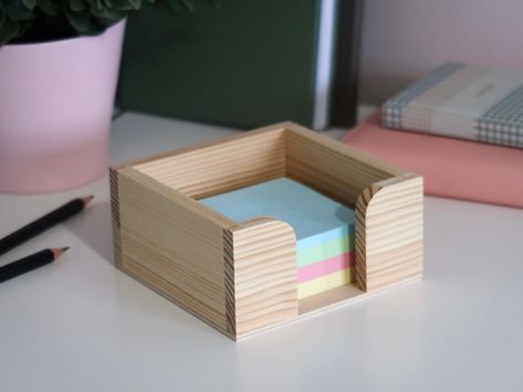 Plain Unfinished Wooden Memo Pad Box Holder. Ideal for organising sticky notes. Dimensions external (L + W + H) 11.2 x 11.2 x 5.5 cm / internal 9.5 x 9.5 x 5.2 cm Transform your workspace with this unique wooden desk memo pad and note dispenser. Its square shape ensures easy access to your notes while seamlessly fitting on any desktop for a tidy and organised look. Crafted from plain, unpainted pinewood, it doubles as a stationery storage box, keeping your essentials handy. The standout feature Post It Storage, Work Office, Desk Tidy, Note Holders, Stationery Storage, Stationery Organization, Wooden Desk, Memo Pad, Clever Design